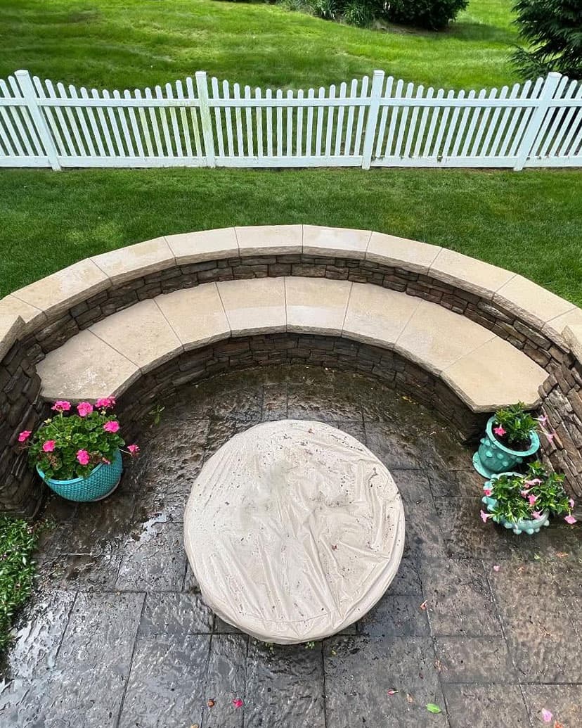 Patio and curved stone seat wall after pressure washing