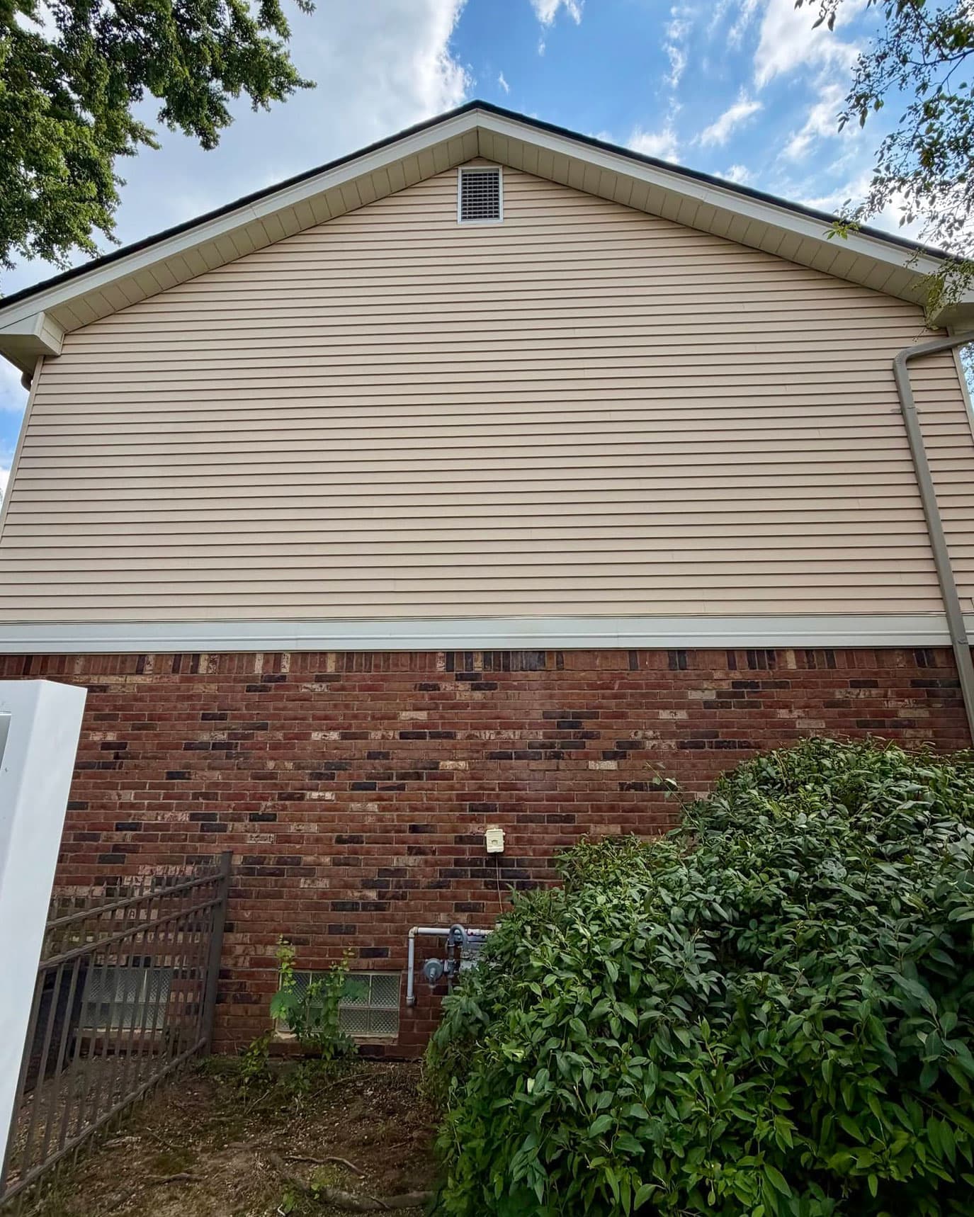 Vinyl siding on a house gable, after cleaning